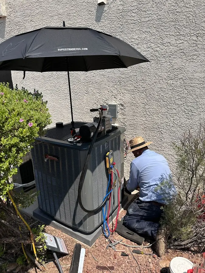 HVAC technician performing outdoor AC maintenance in Treasure Island